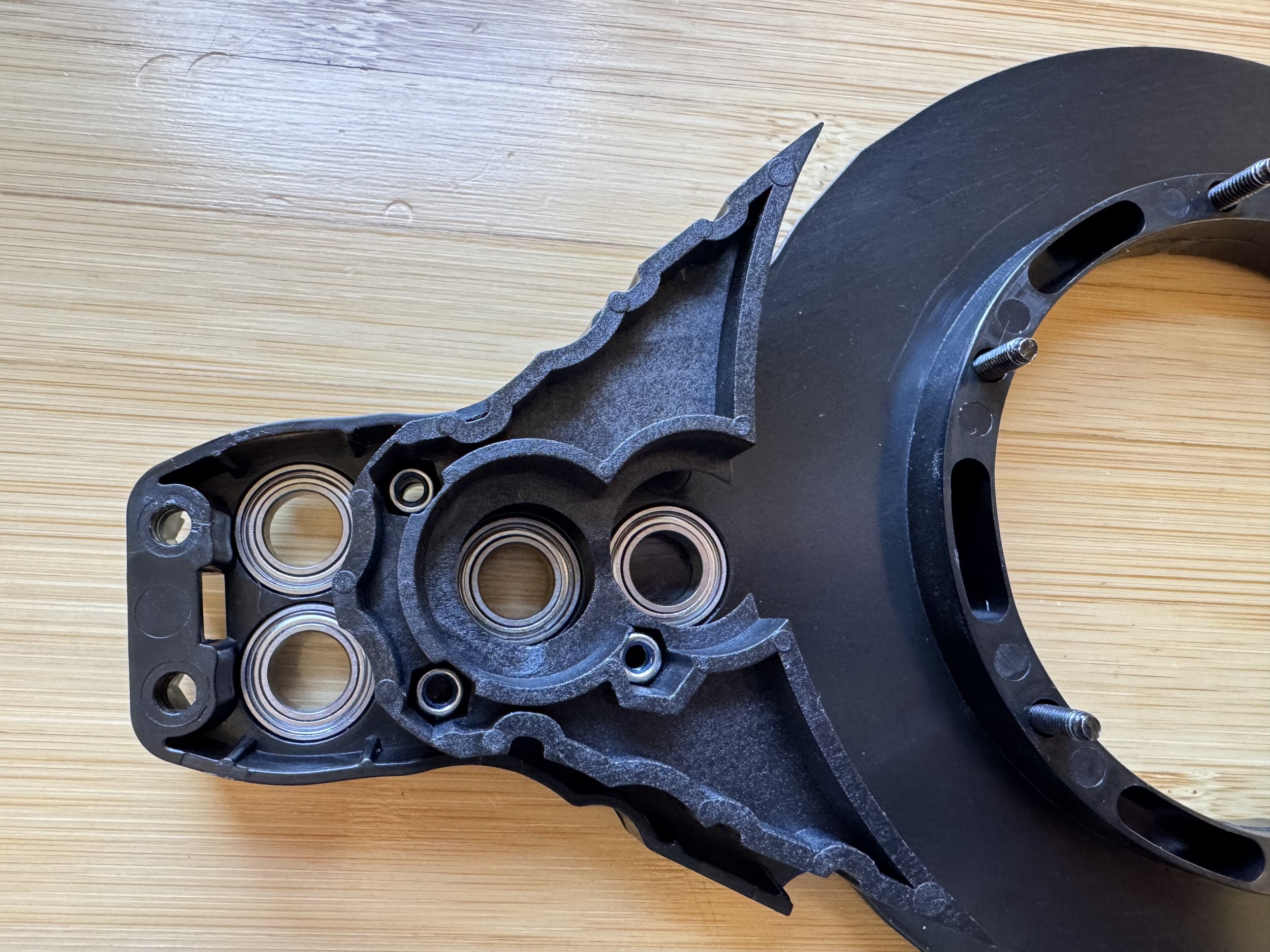 Inserting three nuts into the belt guard