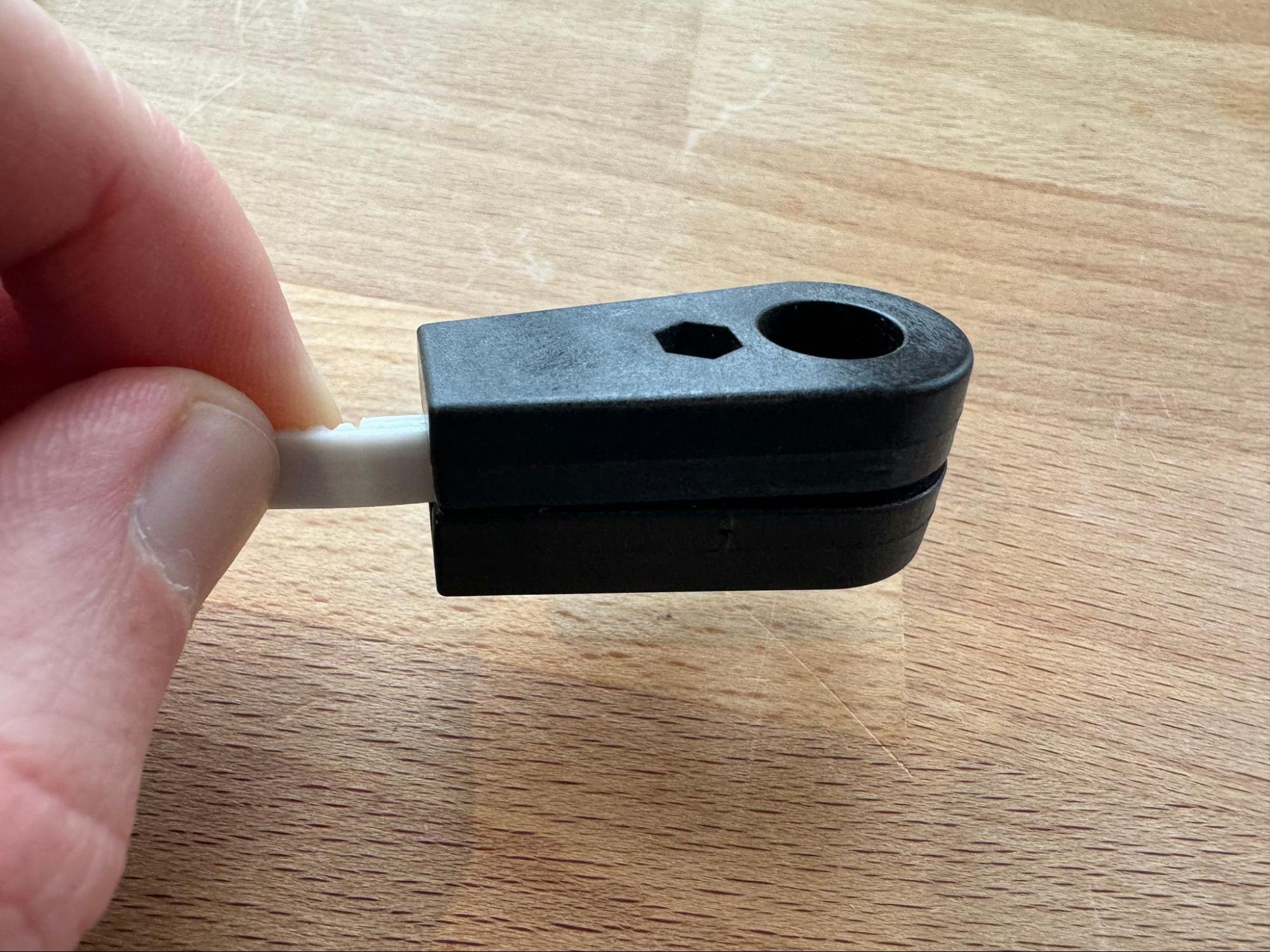 Pressing on the other half of the belt end